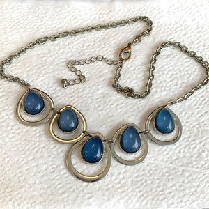 Silver toned metal necklace with 5 blue and silver linked teardrops